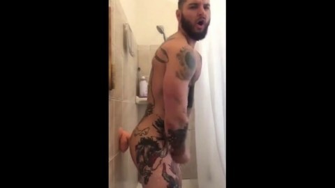 Tatted Hunk Fucks Dildo in Shower Until He Cums