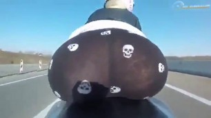 View Blonde biker behind while driving