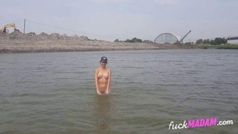 Naked girl masturbates on the river shore