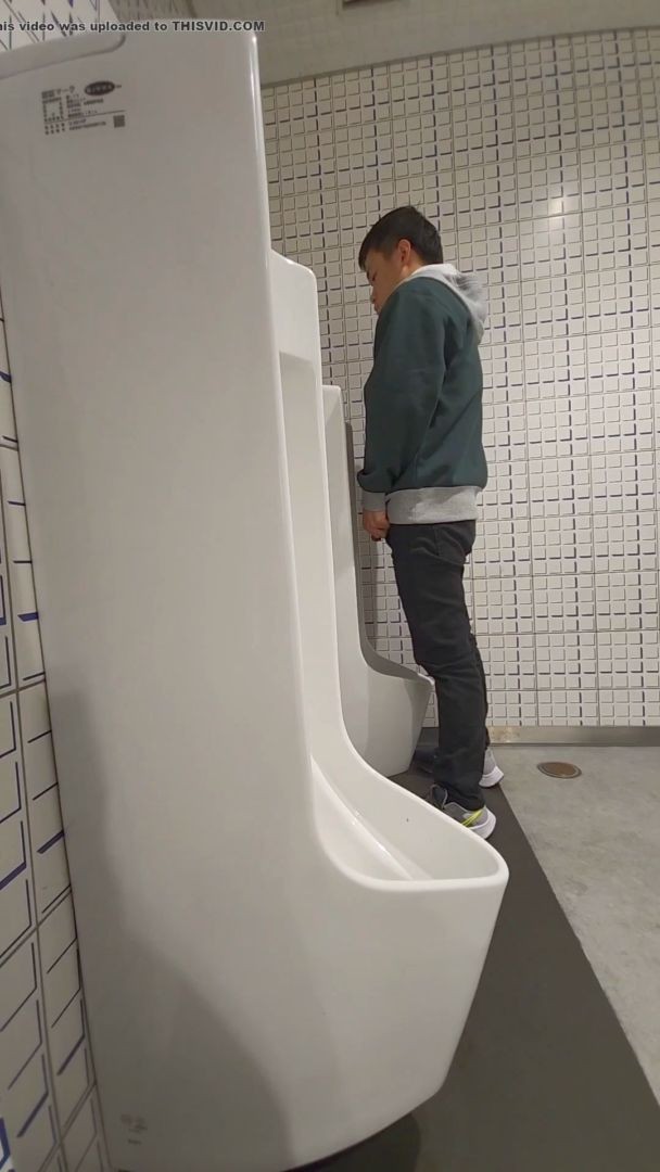 A male is pissing in the toilet 35