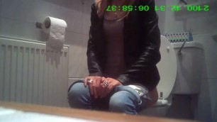 blonde in jeans pissing in public restroom