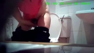 girl in pink panties pissing in a cafe in the toilet