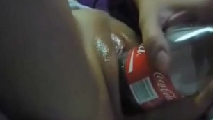 woman fucks herself in the pussy of Coca Cola